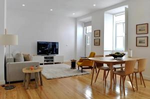 a living room with a table and a couch at Alfama Prime Apartments by Homing in Lisbon