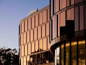 a building with a sign on the side of it at Pullman Sydney Penrith in Penrith