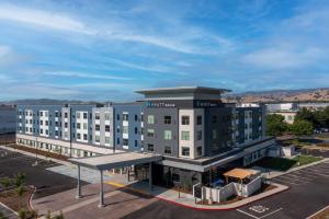 a large building with a parking lot in front of it at Hyatt House Vacaville in Vacaville