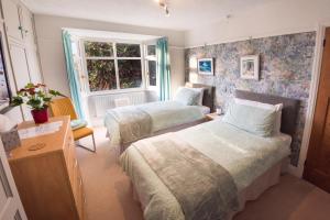 a bedroom with two beds and a window at The Monkey House B&B in Stone