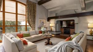 a living room with a couch and a fireplace at VILLA ADISA 8, Emma Villas in Uzzano
