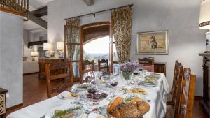 a dining room with a table with food on it at VILLA ADISA 8, Emma Villas in Uzzano