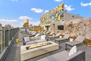 a rooftop patio with couches and a fire pit at Streeterville 2br w lounge pool nr Riverwalk CHI-1003 in Chicago