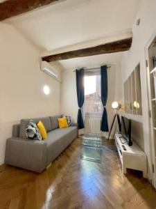 sala de estar con sofá y ventana en T2 calme centre historique AIX EN PCE, en Aix-en-Provence