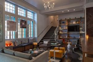 a living room with a couch and a staircase at Le Meridien Dallas, The Stoneleigh in Dallas