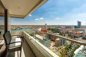 a balcony with a view of a city at The Westin Leipzig in Leipzig