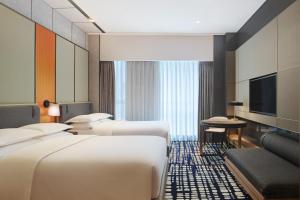 Ένα ή περισσότερα κρεβάτια σε δωμάτιο στο Sheraton Shenzhen Nanshan