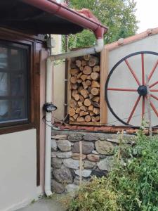 a building with a woodenmill and a pile of logs at Panthea Cottage in Stavroupoli