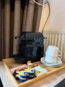 a coffee maker sitting on top of a wooden table at Hotelkamer Prinsenstraat with Free Parking in Groningen