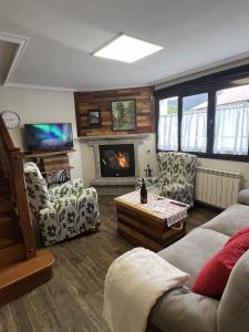 a living room with a couch and a fireplace at Casa Boni y Florina in Nava