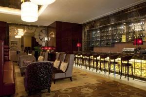a dining room with chairs and a bar at Sheraton Changzhou Xinbei Hotel in Changzhou