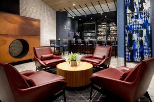 a lobby with chairs and a table and a bar at Fairfield Inn & Suites by Marriott New York Manhattan/Times Square South in New York