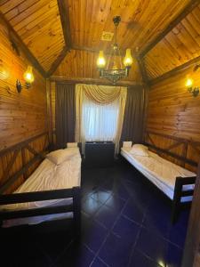 a bedroom with two beds in a wooden cabin at Хостел 24 in Khmelnytskyi