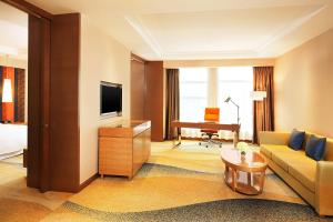 a living room with a couch and a television at Four Points by Sheraton Bijie in Bijie