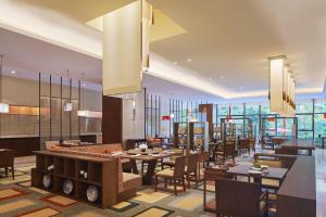 a rendering of a restaurant with tables and chairs at Four Points by Sheraton Guangdong, Heshan in Heshan