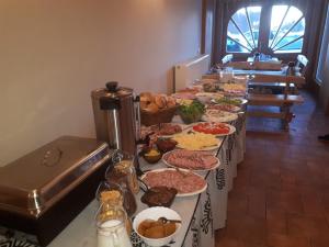 a buffet line with many different plates of food at OW Zakopiec in Zakopane