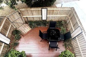 an overhead view of a wooden deck with chairs and tables at A touch of lux in the Redlands! in Capalaba