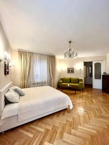 a bedroom with a bed and a living room at Апартаменты в самом центре столицы. in Kyiv
