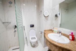 a bathroom with a toilet and a sink and a shower at Alolayan Diamond Hotel in Mecca +17 photos