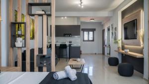 a room with a bed and a living room and a kitchen at ALBA SUITE APARTMENT in Kalabaka