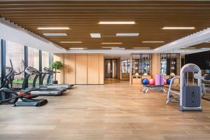 a gym with treadmills and exercise equipment in a room at Fairfield by Marriott Taiyuan South in Taiyuan