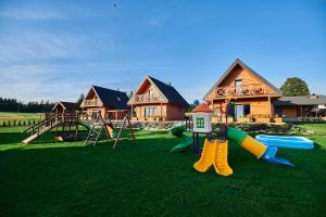 a playground in front of a house with a play yard at Osada Orlica 3 in Lasowka