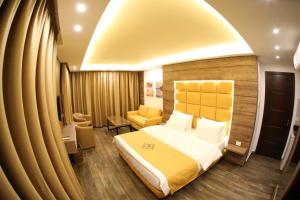 a hotel room with a bed and a chair at Batroun boutique suites in Batroûn +82 photos