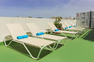 a row of chaise lounge chairs on a roof at Los Cantaros in El Puerto de Santa María