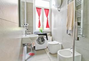 a bathroom with a sink and a washing machine at Domvs Romae Apartment in Rome +21 photos