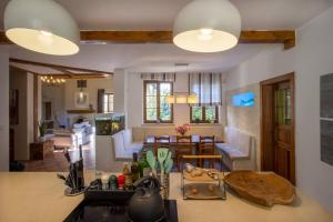 a kitchen and a living room with a table and a kitchen at 7 Bedroom Secluded Villa close to Prague in Ricany +27 photos
