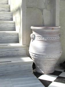 a large white vase sitting next to a window at Castellino Studios in Faliraki +146 photos