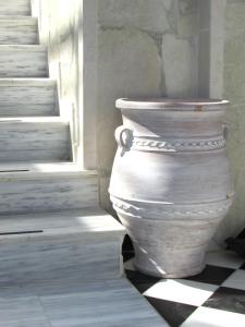 a large white vase sitting next to a window at Castellino Studios in Faliraki
