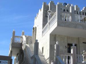 a building with stairs leading up to a balcony at Castellino Studios in Faliraki