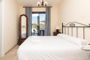 a bedroom with a large white bed and a window at 2233-Lovely 2 bedrooms on the beach, pool and port in Manilva +19 photos