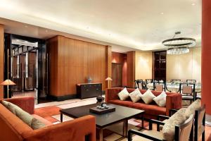 a living room with couches and a table and a dining room at Four Points by Sheraton Chengdu, Anren in Dayi