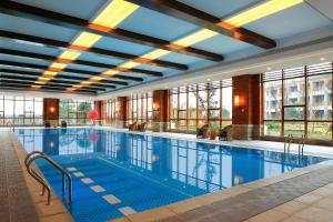 a large swimming pool in a building with windows at Four Points by Sheraton Chengdu, Anren in Dayi