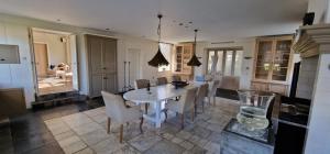 a dining room with a white table and chairs at Amsterdam Mansion - The Studio in Oostzaan