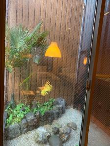 a fish tank with a lamp in a room at SAKARA KYOTO 桜香楽 京都 in Kyoto