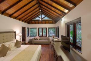 a living room with a bed and a couch at The Deer Park Hotel in Giritale