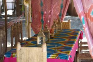 a table with a blue and yellow table cloth at Dar Tawarta Guest House Dakhla in Dakhla