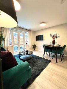 ein Wohnzimmer mit einem grünen Sofa und einem Tisch in der Unterkunft Damson Drive- Boutique Home in Oldbury