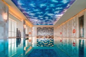 a swimming pool with a mural of a sky at Le Méridien Yixing Hotel in Yixing
