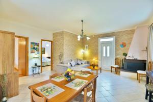 a living room with a couch and a table at Drossos Garden House in Nydri