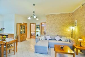 a living room with a couch and a table at Drossos Garden House in Nydri +19 photos