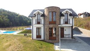 a house on a hill next to a pool at Royal King in Vrnjačka Banja