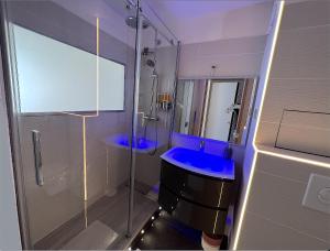 a bathroom with a blue sink and a shower at EXCEPTIONNEL sur CANNES vue mer piscine in Cannes