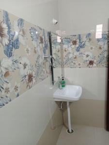 a bathroom with a sink and a mirror at KPHB Phase 15 New Stunning 3 BHK - 5th Floor with Private Parking in Hyderabad