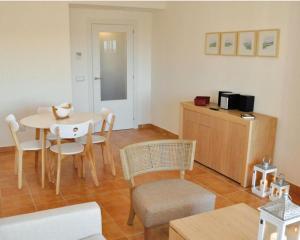 a living room with a table and chairs and a kitchen at 2127-Superb 2 bedrooms , lovely terraces and pool in San Roque
