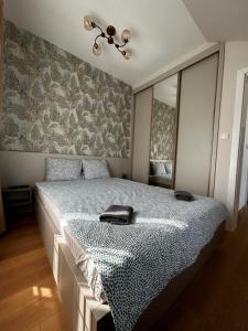 a bedroom with a large bed with a mirror at Royal King in Vrnjačka Banja