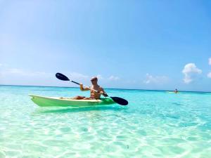 a man is sitting in a kayak in the ocean at VIVA Beach Maldives in Hangnaameedhoo